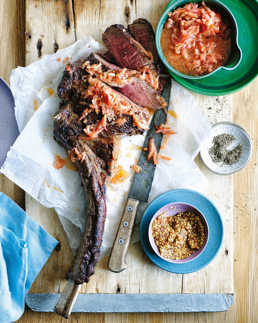 Grilled tomahawk steak with salsa and mustard