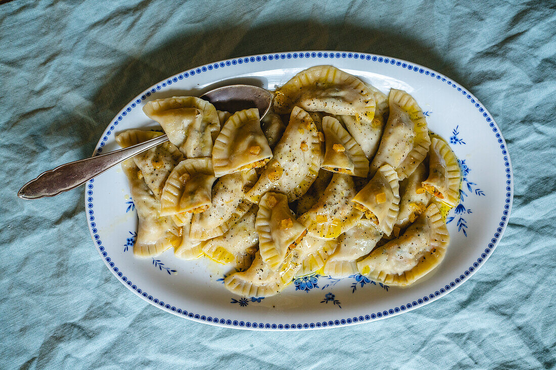 Pierogi with sauerkraut and mushroom filling and vegan butter