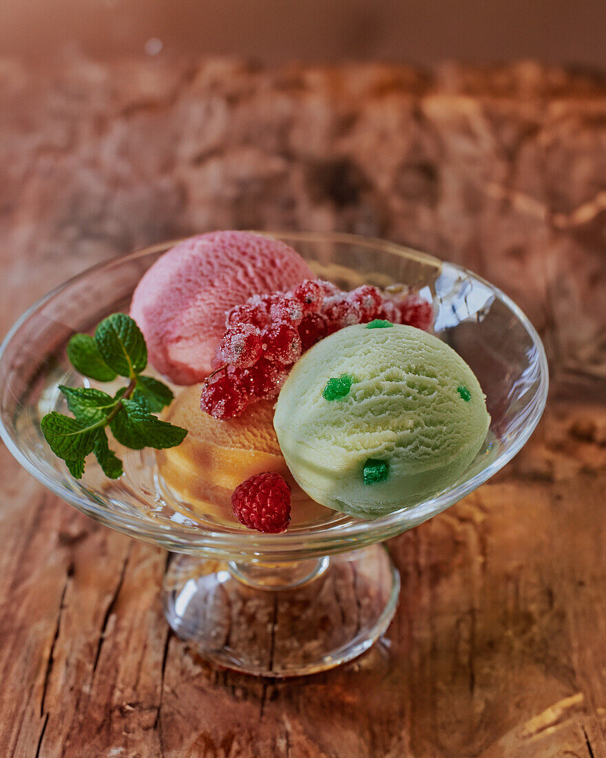 Three kinds of sorbet with mint and raspberries