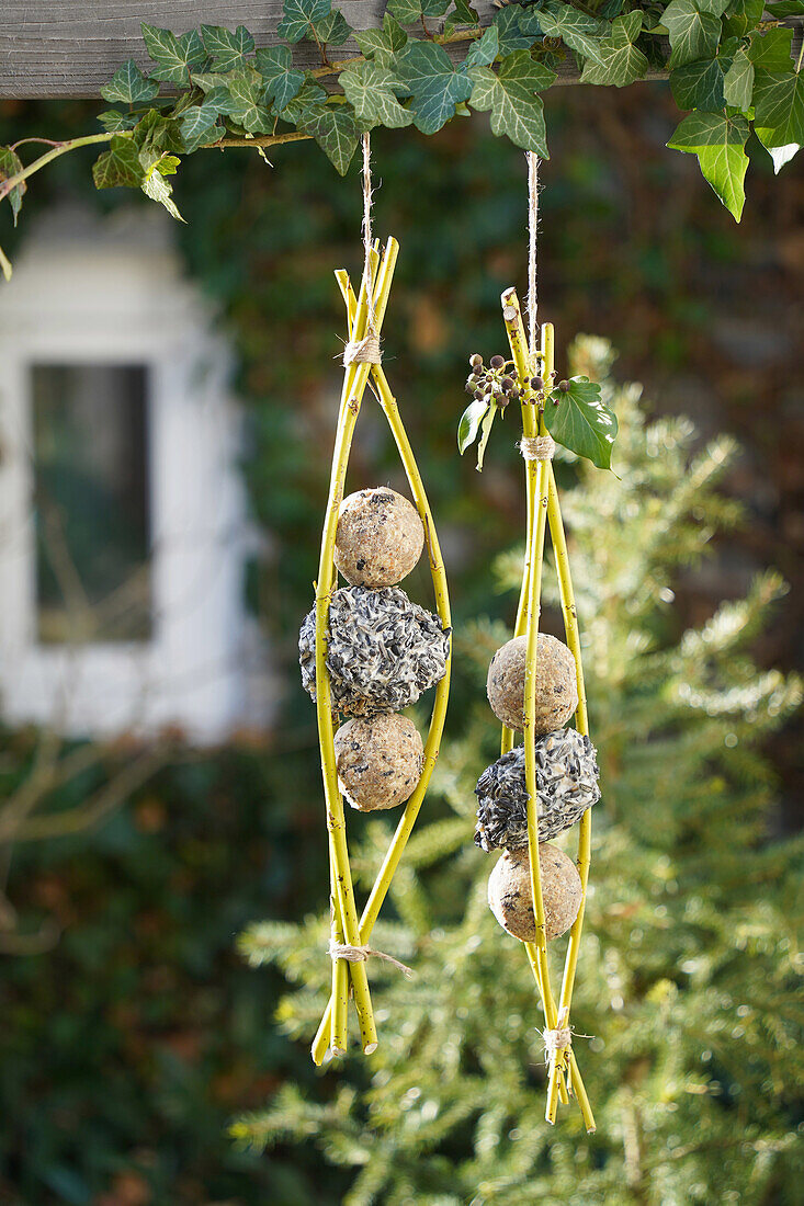 Homemade bird feeder made of willow branches in the garden