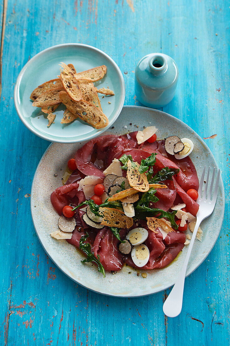 Bresaola carpaccio with truffle oil, parmesan and quail eggs