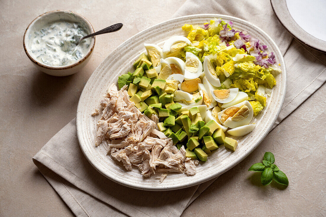 Chicken and avocado salad with eggs and yoghurt dressing