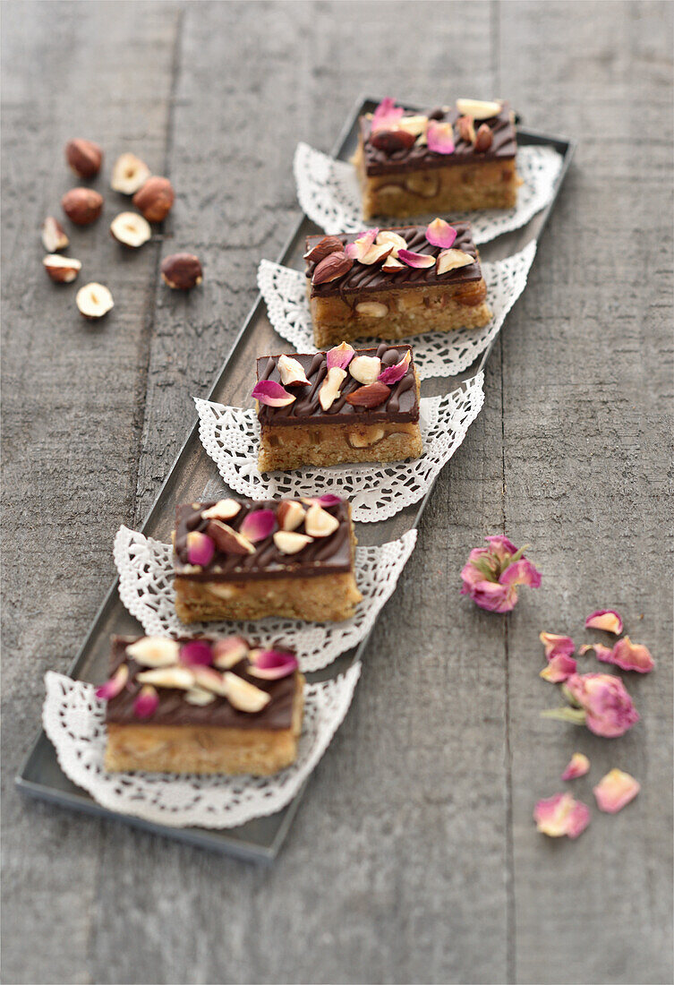 Date caramel chocolate bar with nuts and rose petals