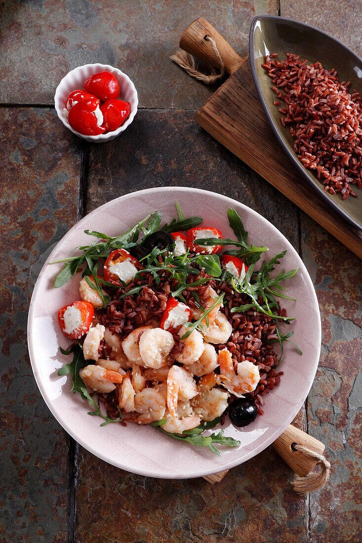 Fried prawns on wild rice with rocket and stuffed cherry tomatoes