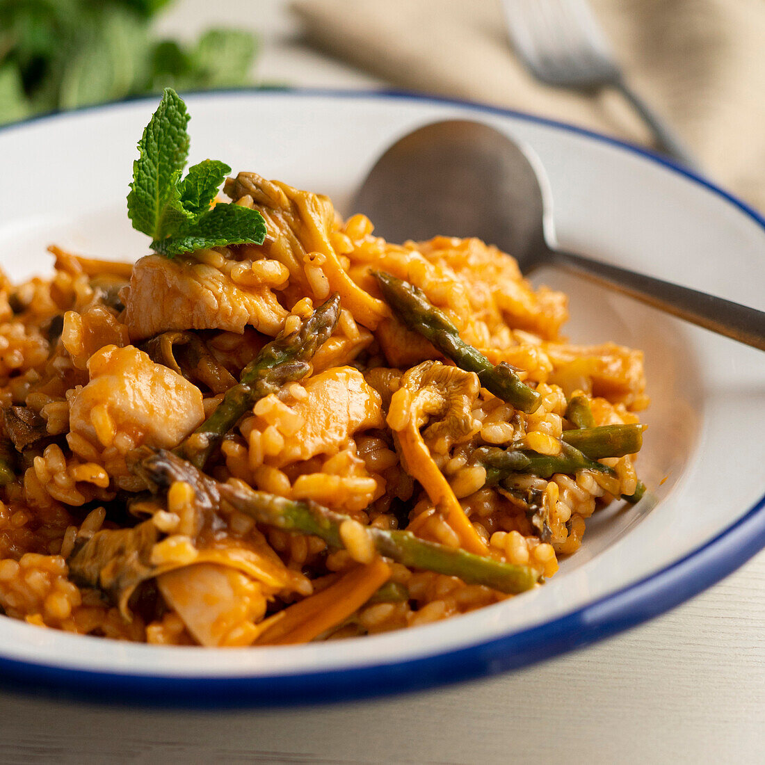 Paella with chicken and green asparagus