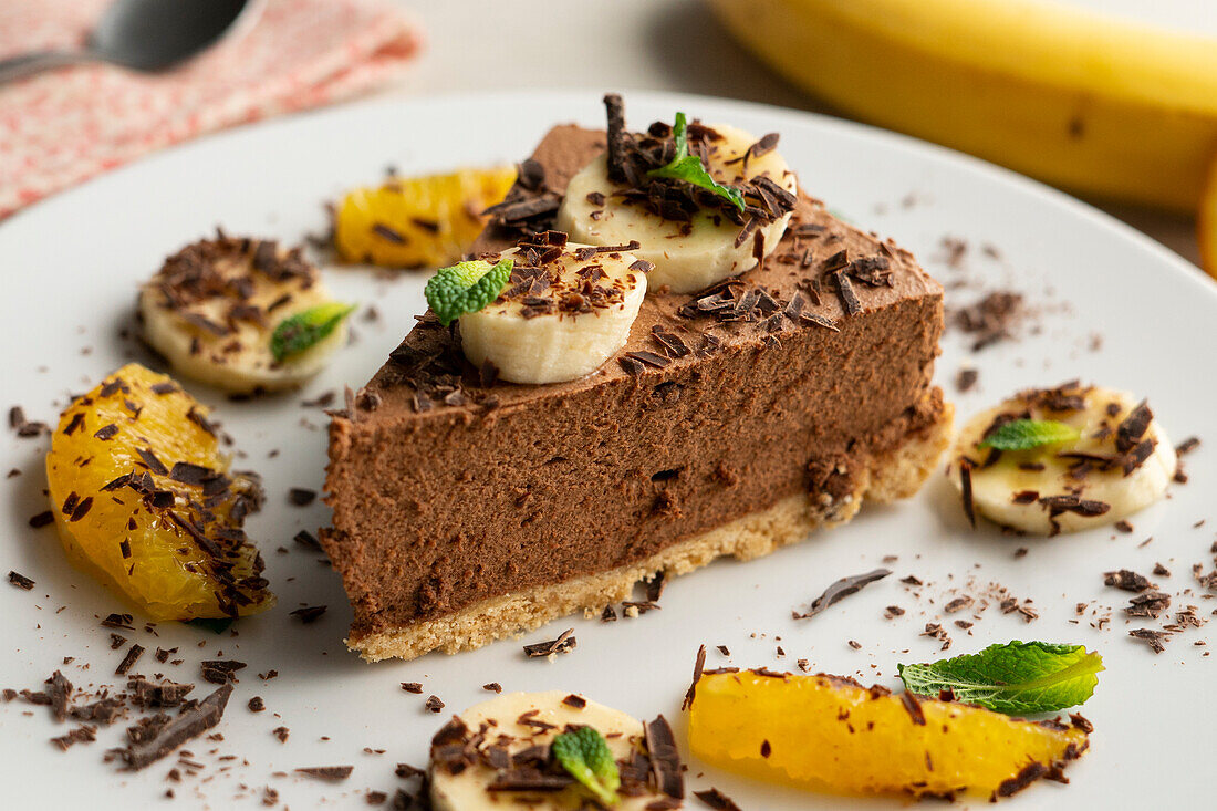 Chocolate mousse tart with bananas and oranges