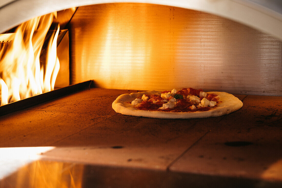 Pizza im brennenden Pizzaofen
