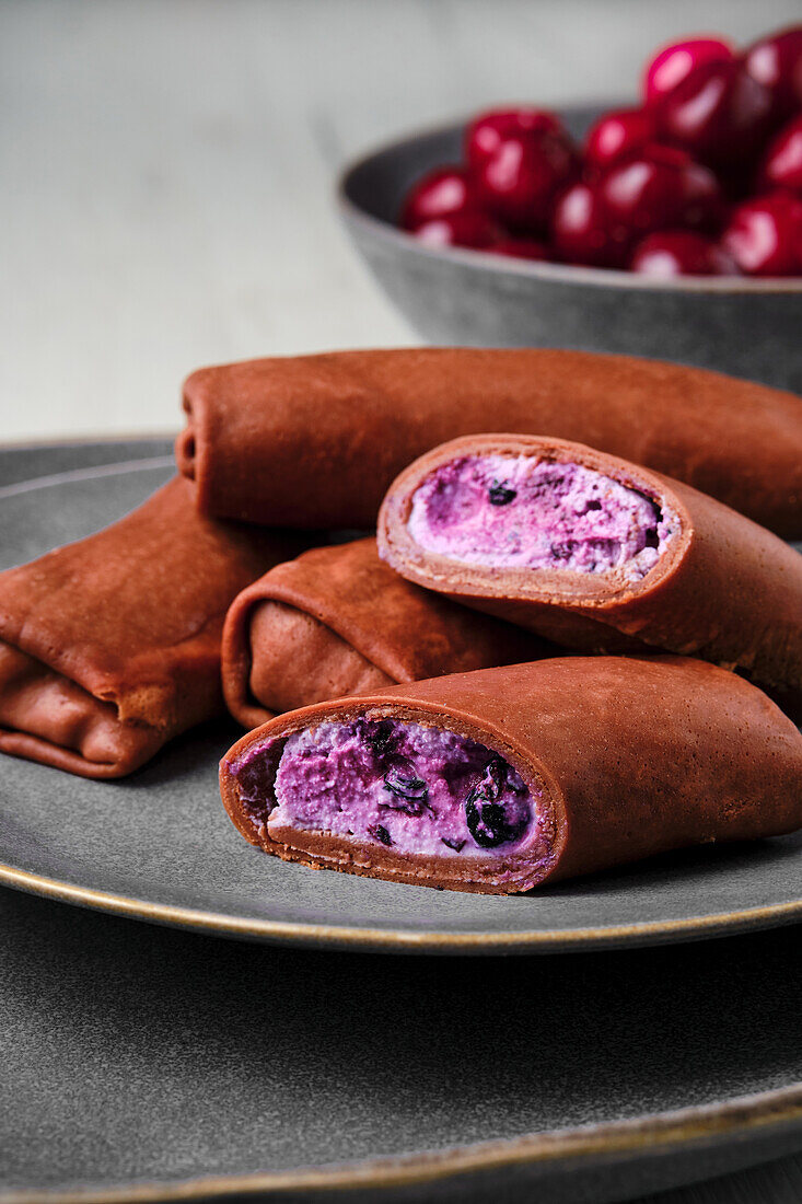 Chocolate crepes with quark and blueberry and cherry filling