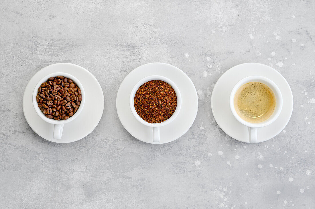 Cups of coffee beans, ground and brewed espresso