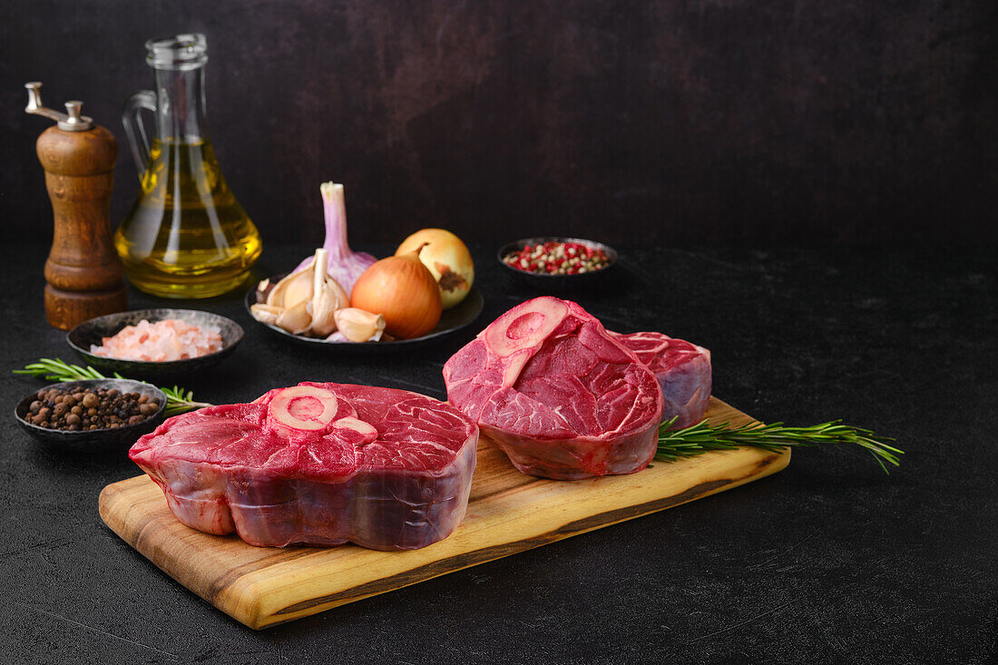 Raw beef leg slices with spices and olive oil