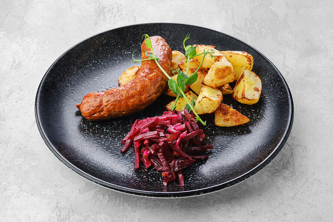 Bratwurst with fried potatoes and beetroot salad