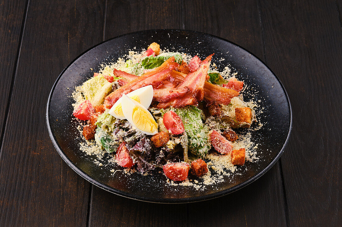 Caesar salad with bacon, egg and parmesan