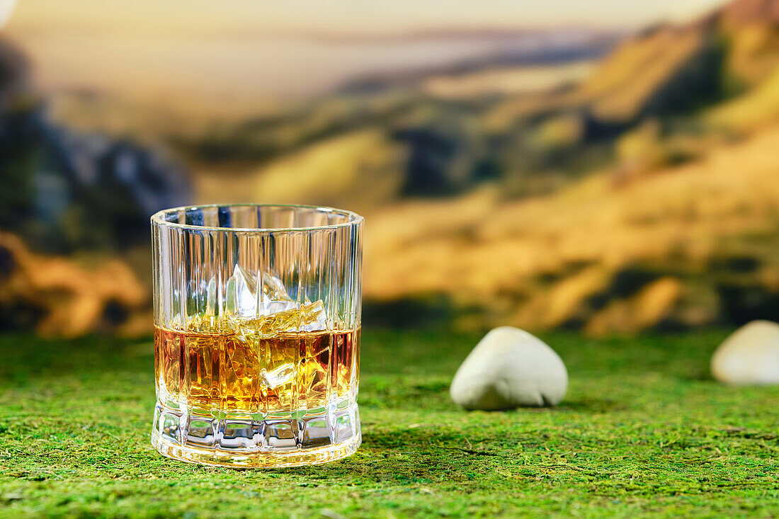 Glass of Scotch single malt whisky on a mossy base