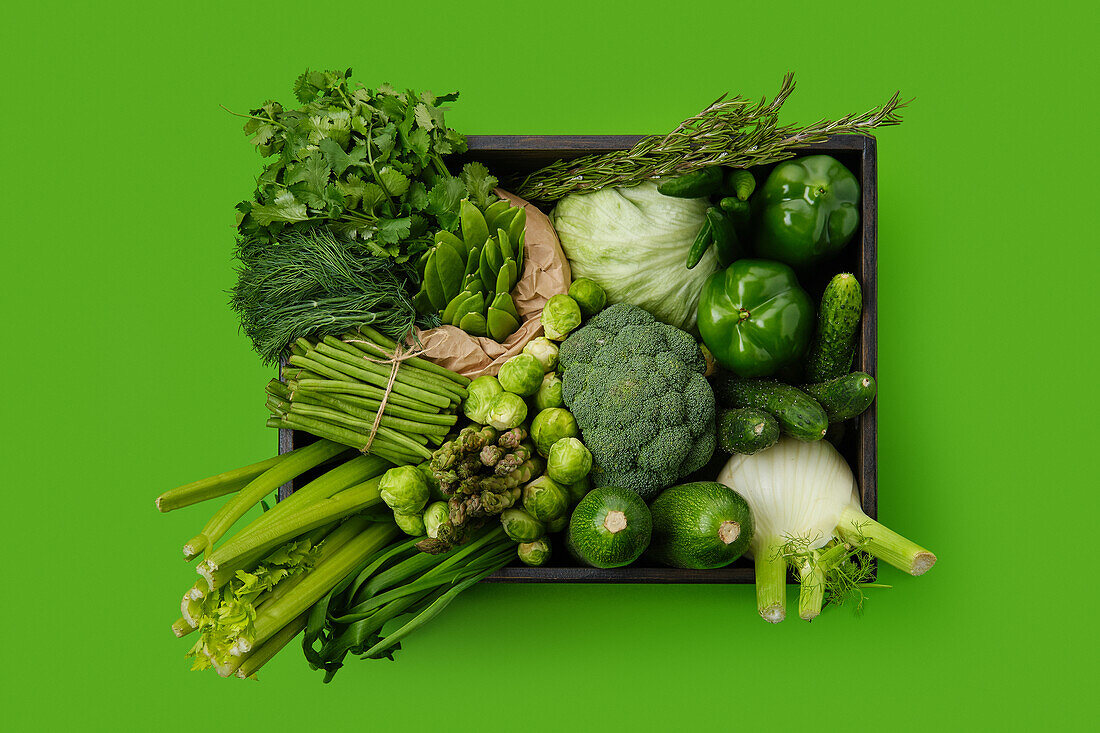 Various green vegetables in wooden box