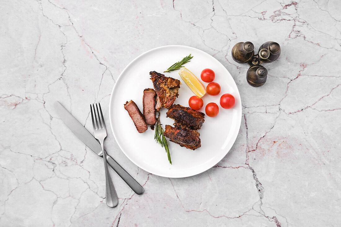 Roast saddle of lamb with rosemary and cherry tomatoes