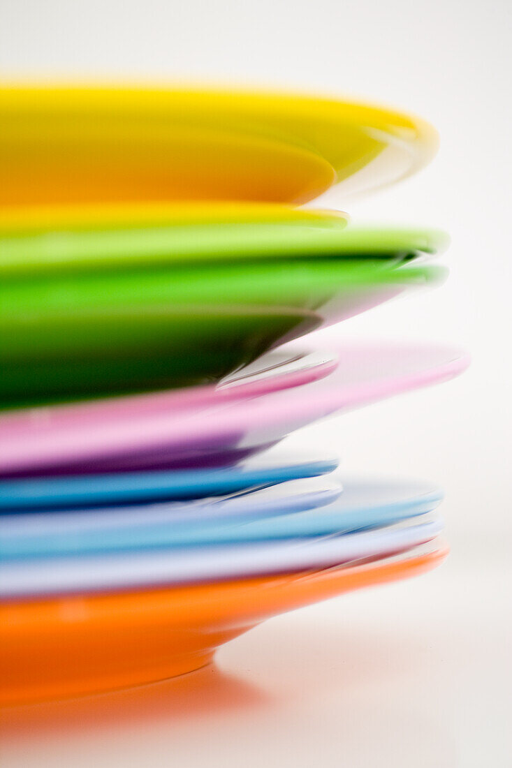 Stacked colourful plastic plates