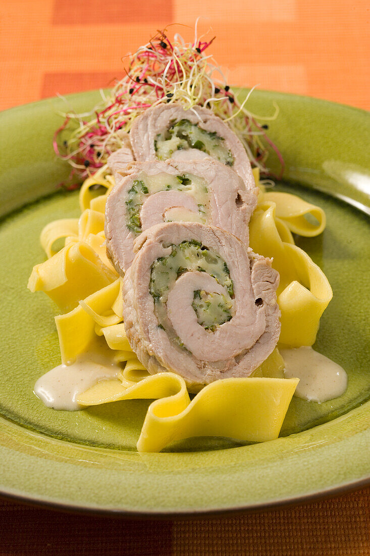 Veal rolls with watercress filling on ribbon noodles