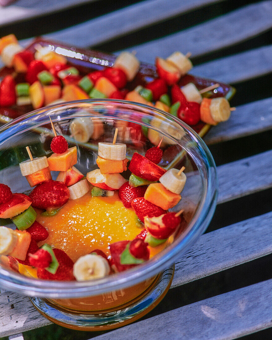 Fruit skewers with mango sauce