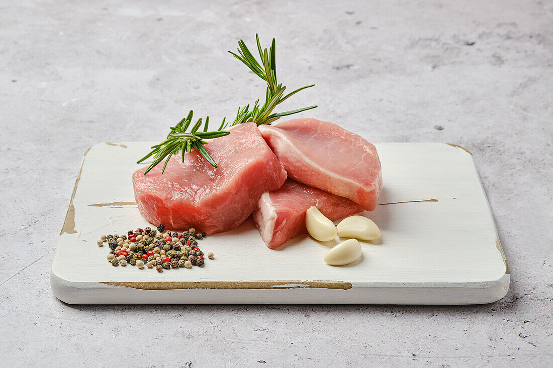 Raw pork chops with rosemary and spices