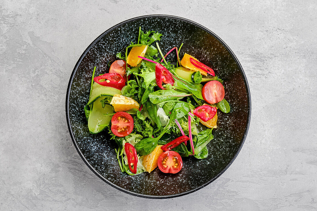 Salad with orange, chilli, tomato, cucumber and avocado