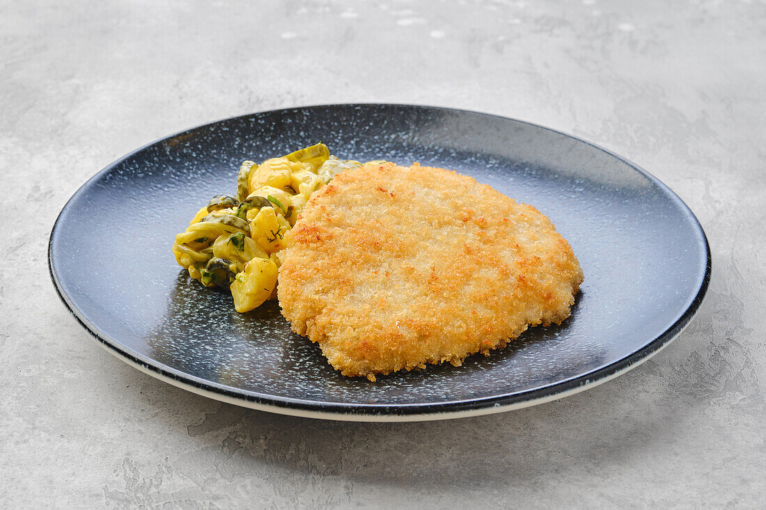 Pork schnitzel with potato and cucumber salad