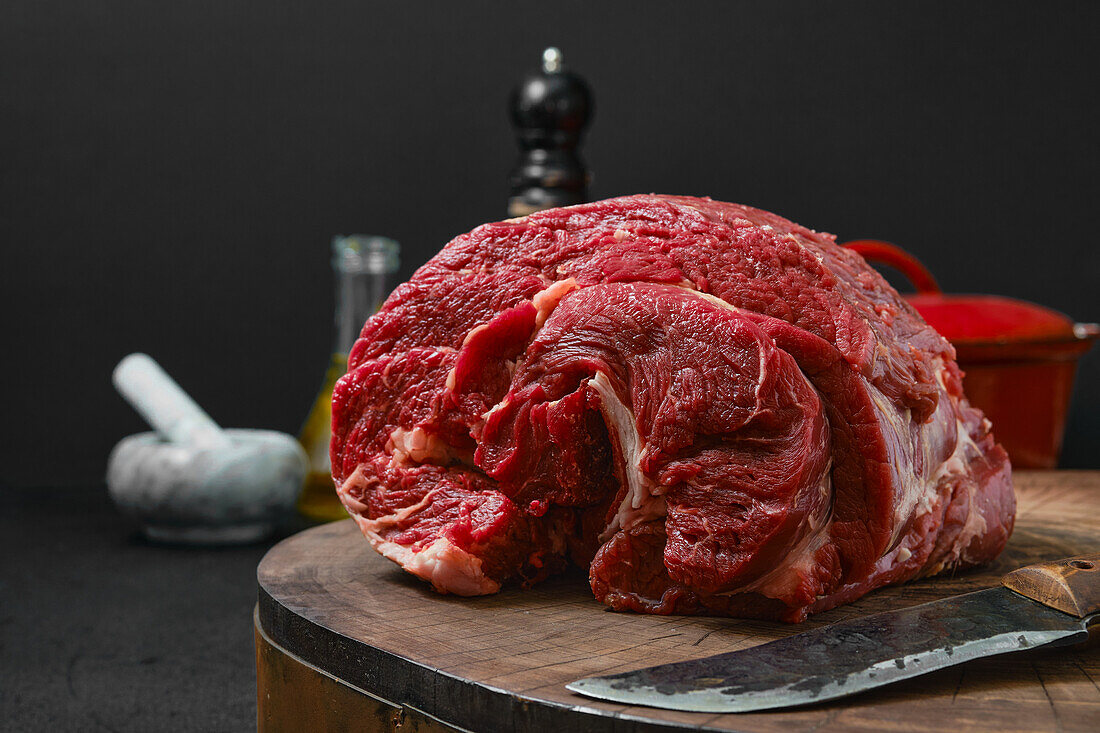 Raw beef neck on a wooden board