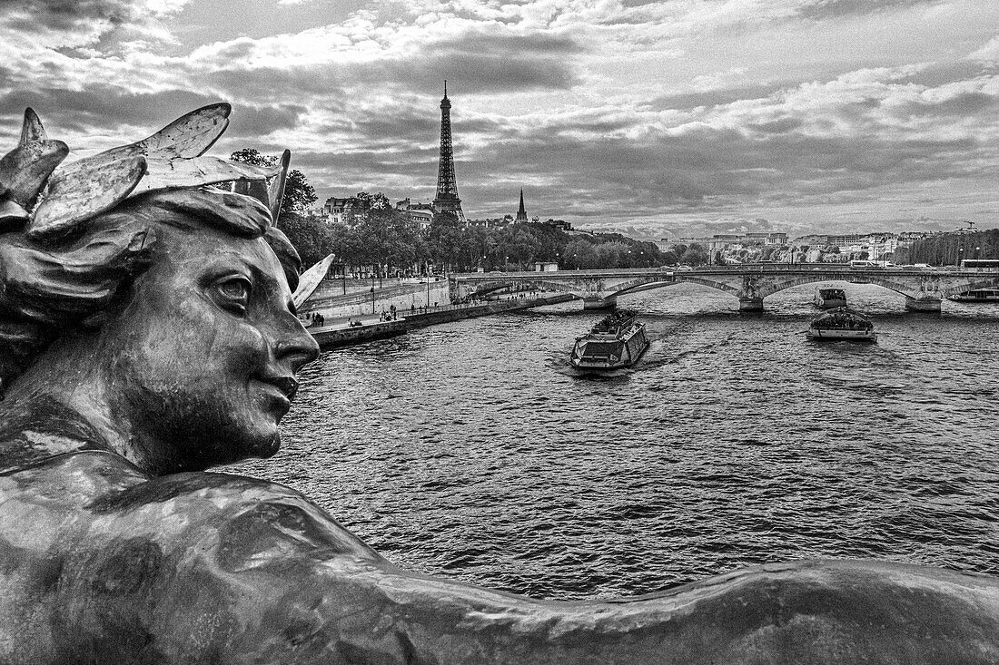 Paris. Nymphes de la Seine statue on Pont Alexandre III, along River Seine. Distant Eiffel Tower.