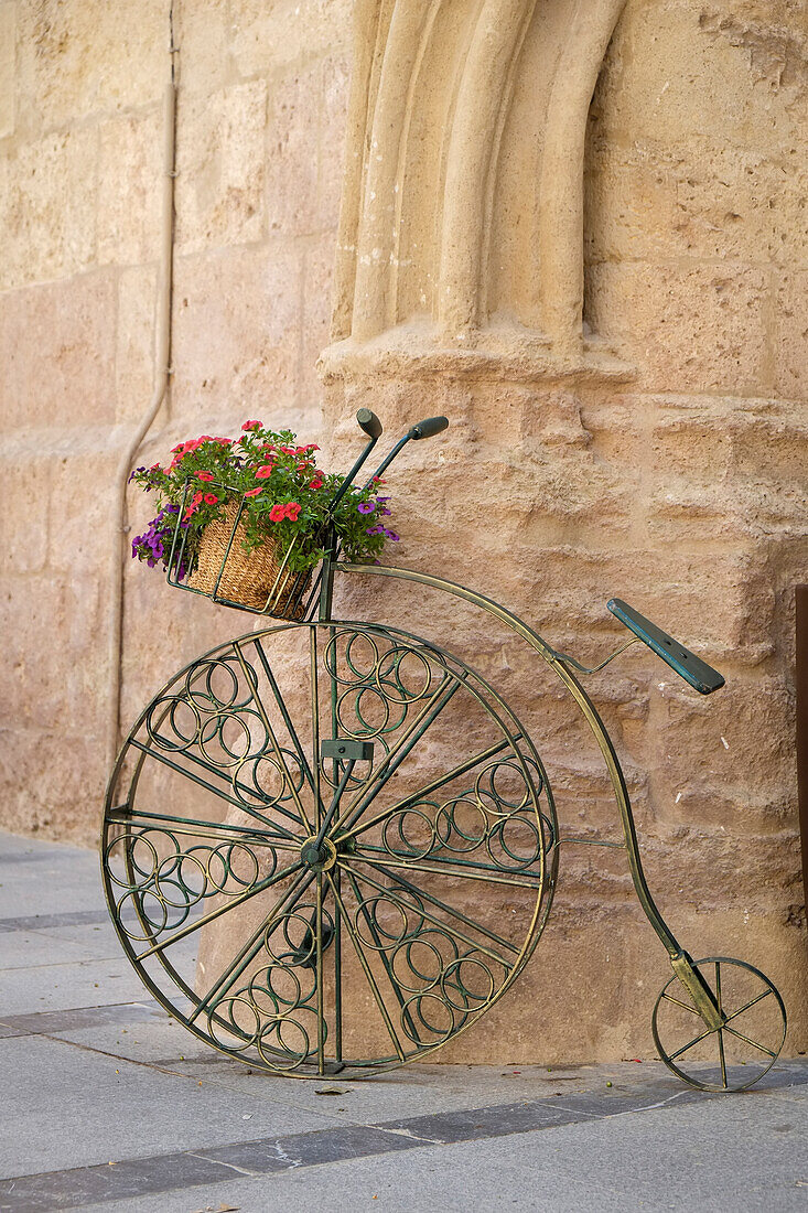 Cordoba, Spain. Bicycle planter in front of old stone building