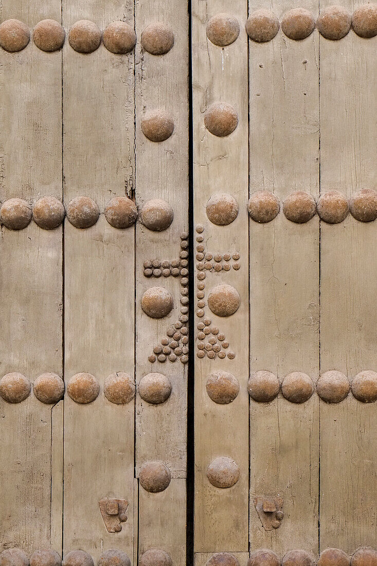 Cordoba, Spain. Ancient wooden door with cross