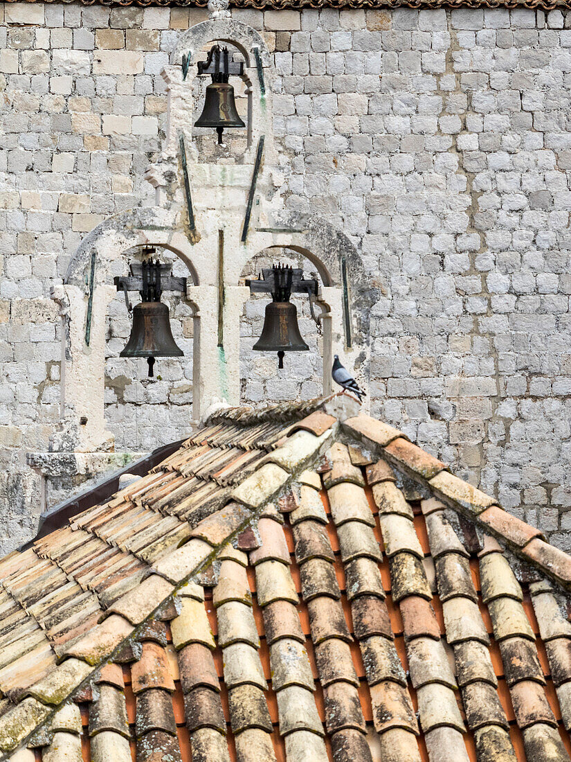 Croatia, Dubrovnik. Bell tower with three bells on top of the Church of Our Lady of Mt. Carmel.