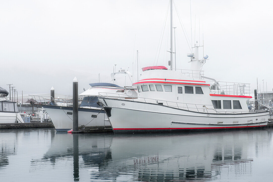 Alaska, Valdez. Two fishing boat in a foggy marina.