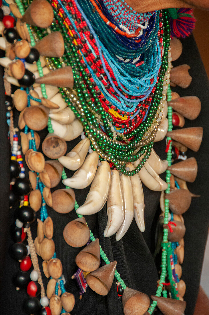 The elaborate regalia of a shaman in the Amazon jungle features jaguar teeth and beads.