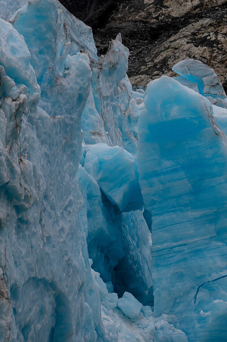 Ice glows brilliant blue at the terminus of Margerie Glacier.