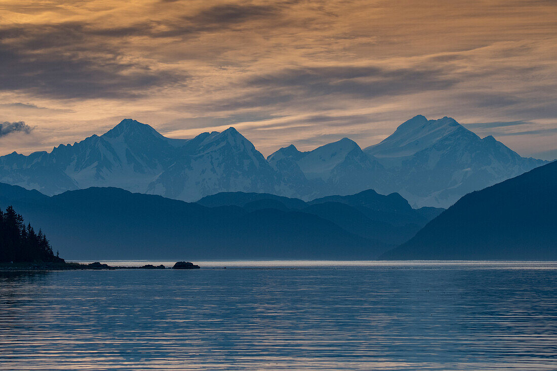 Der Sonnenuntergang beleuchtet die hohen Berge der Glacier Bay.