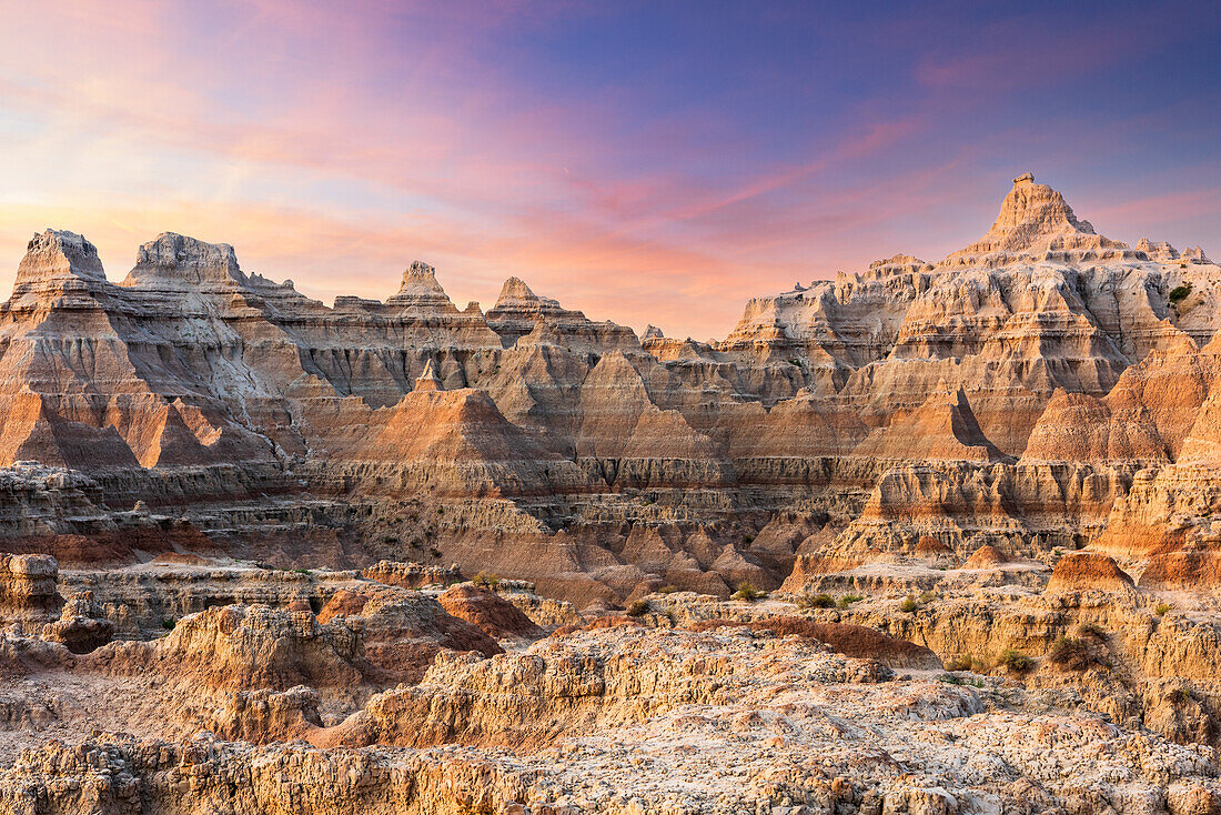 Magnificent set of striated hoodoos set against the backdrop of sunset colors in the sky.