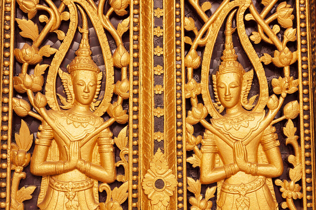 Laos, Luang Prabang. Golden relief carvings.