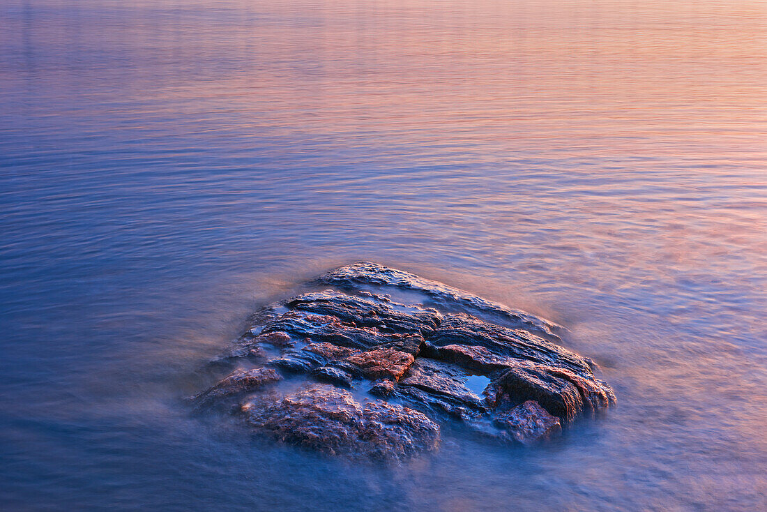 Kanada, Manitoba, Paint Lake Provincial Park. Paint Lake. Freiliegende Felsen am Paint Lake bei Sonnenaufgang.