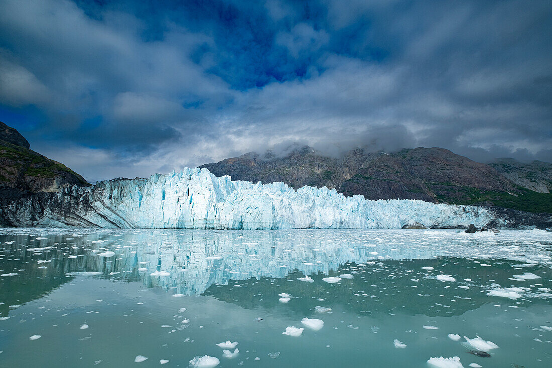 Der Margerie-Gletscher spiegelt sich in dieser ruhigen Wasseransicht.
