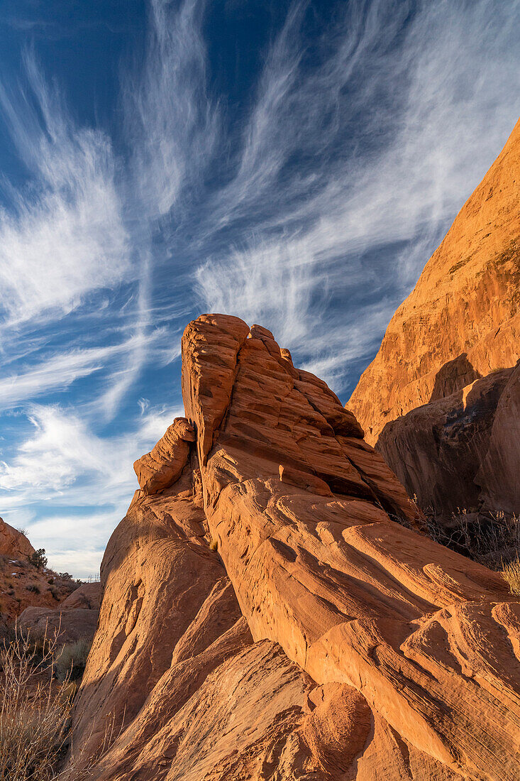 USA, Utah. Mare's Tails (Cirrus uncinus) and sandstone formations, Sand Flats Recreation Area, near Moab.