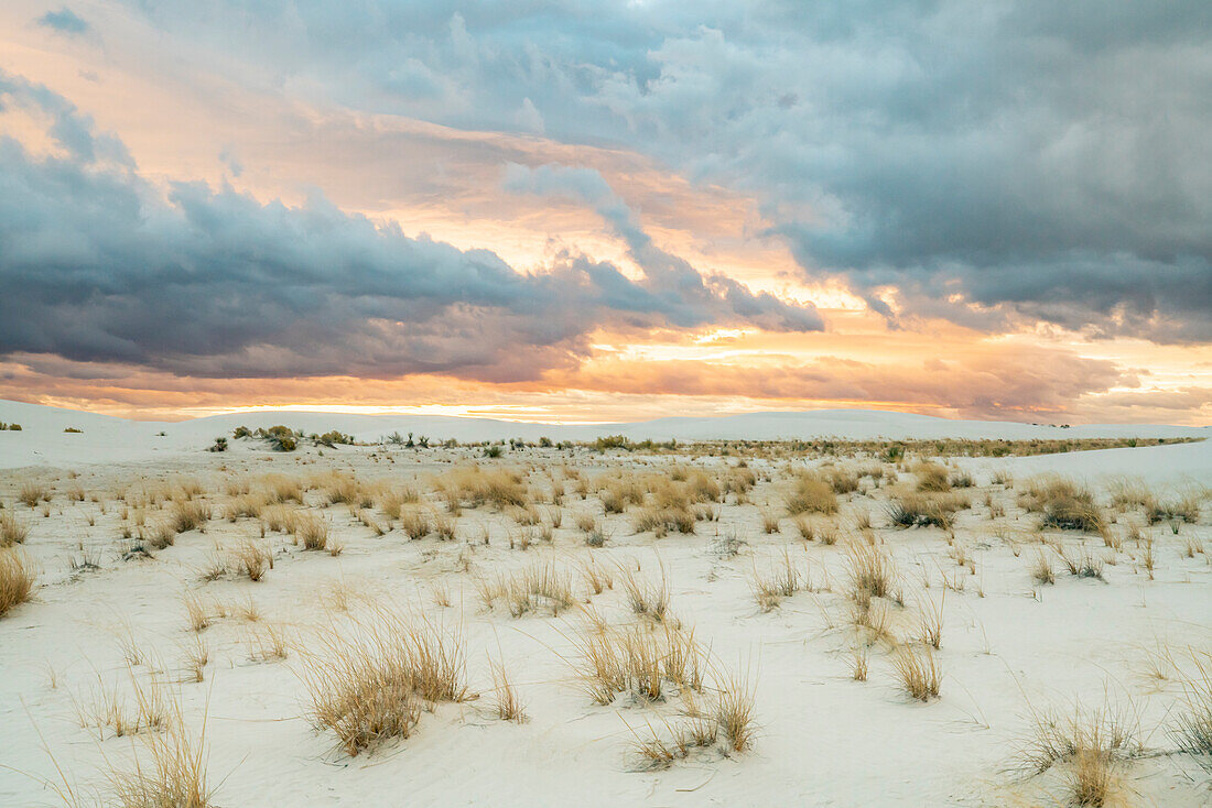 USA, New Mexico, White Sands National Monument. Clouds over sand dunes.