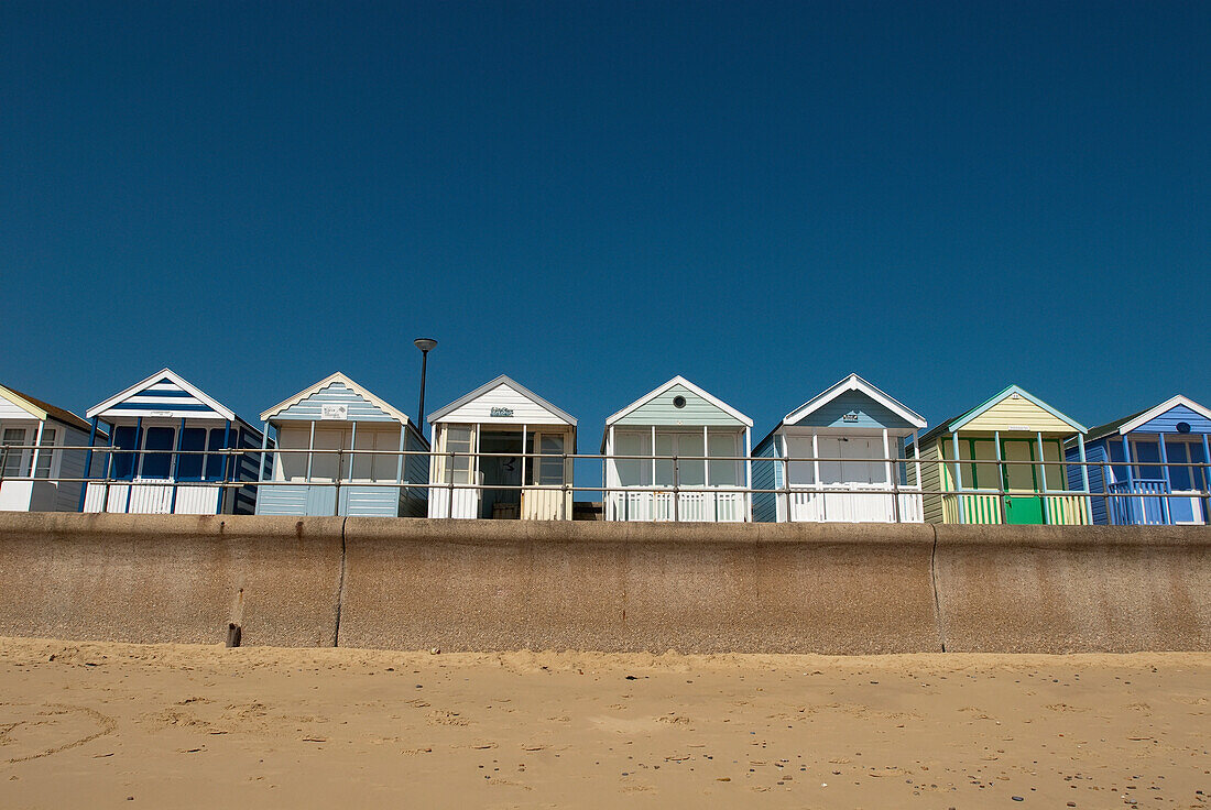Traditional beach huts on the seafront at Southwold, Suffolk, UK