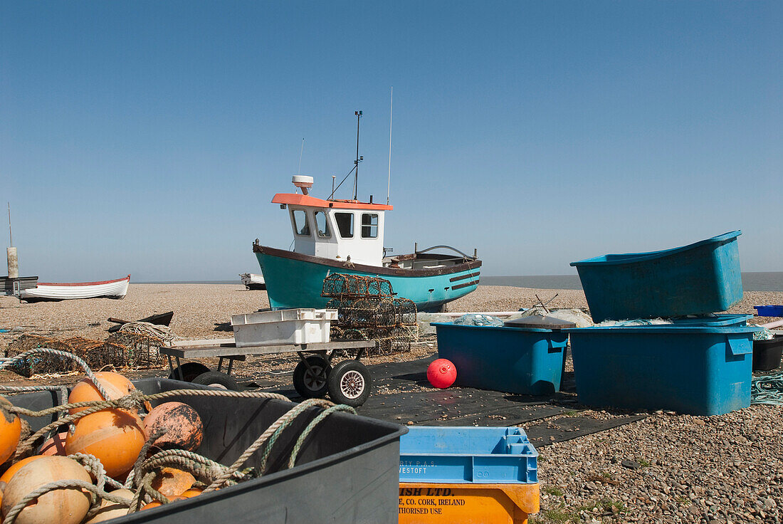 Fishing boats pulled to shore on Aldeburgh beach, Suffolk, UK