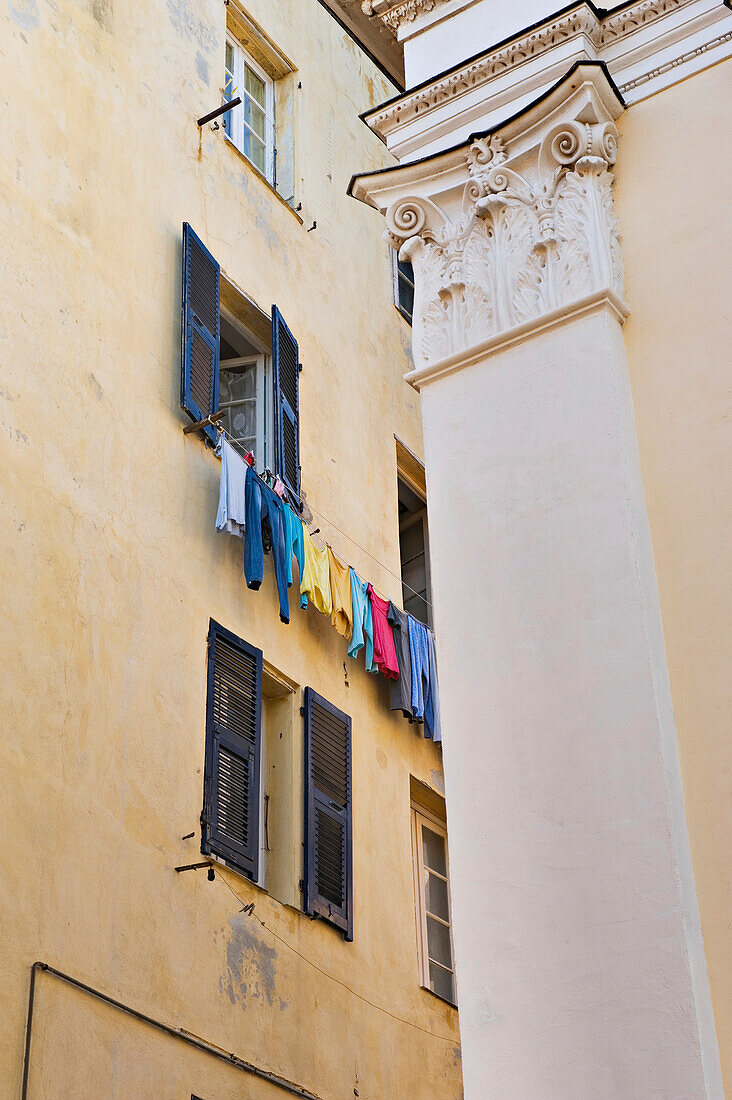 A washing line full of colourful clothes in the Terra Nova district of Bastia. Corsica. France.