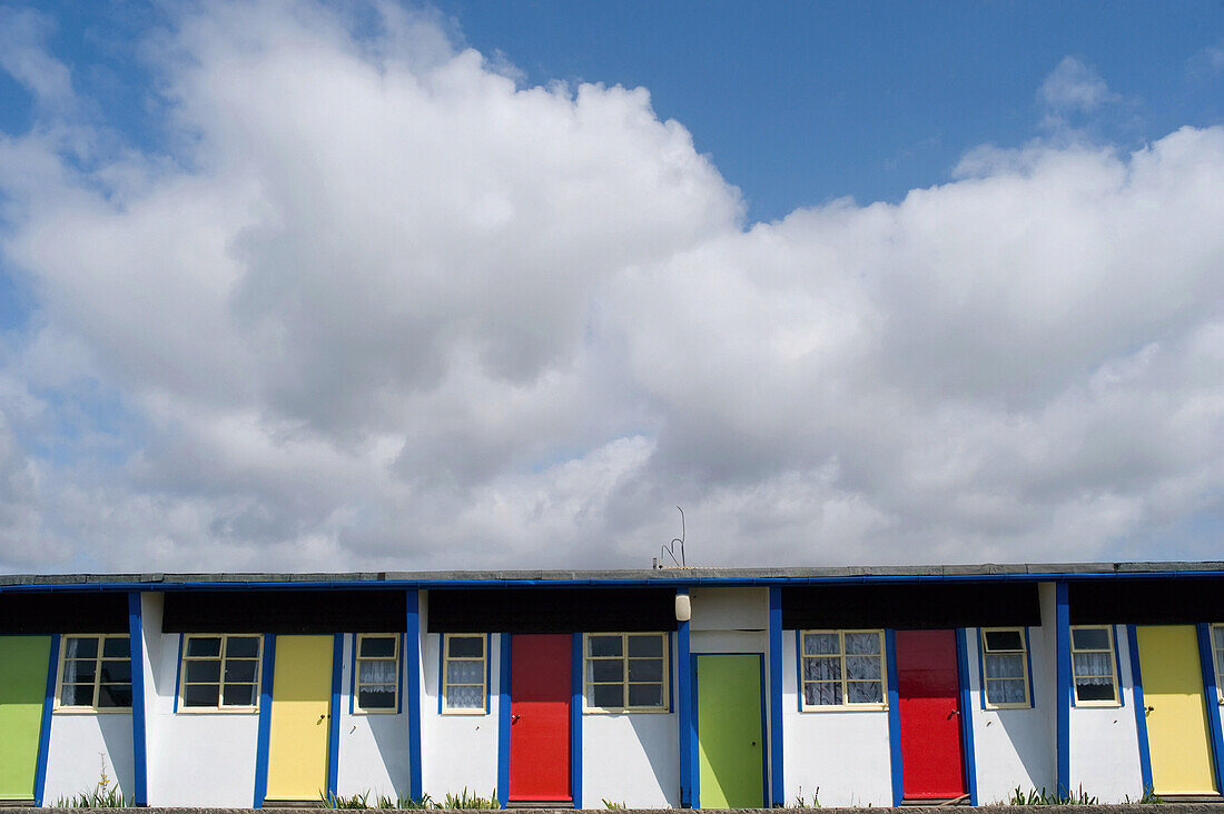 Colourful doorways in a row in Brighstone Holiday Centre; Isle of Wight, England