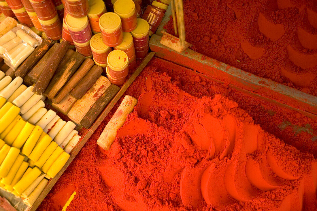 Close-up of red tika powder and other offerings used to worship Shiva, stall in bazaar, holy city of Omkareshwar, Madhya Pradesh, India, Omkareshwar, Madhya Pradesh, India.