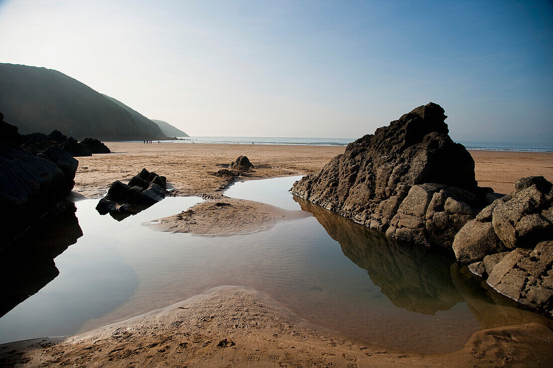 Large Rock Pool On The Beach Surrounded By Rocks In Putsborough Sands, North Devon, Uk