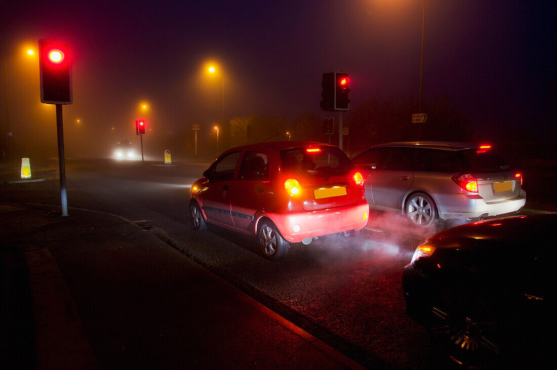 View of city traffic on foggy night; United Kingdom
