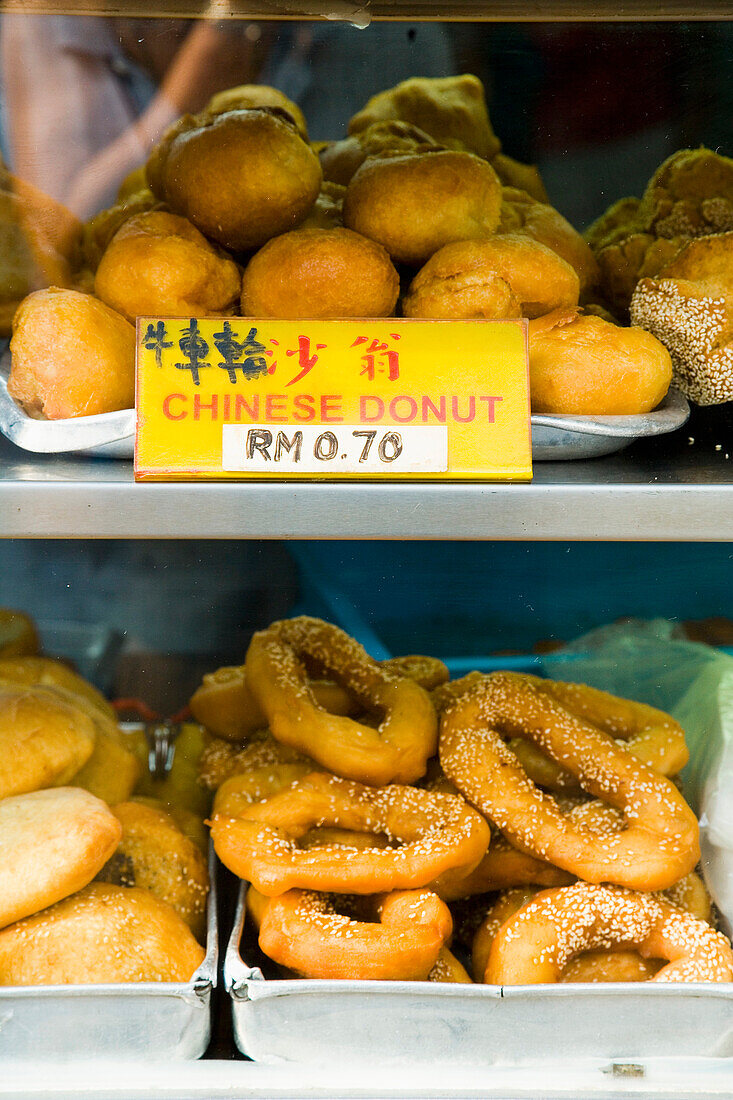 Malaysia, Kuala Lumpur, Chinatown, Chinese donuts for sale out in street; Jalan Petaling (Petaling Street)