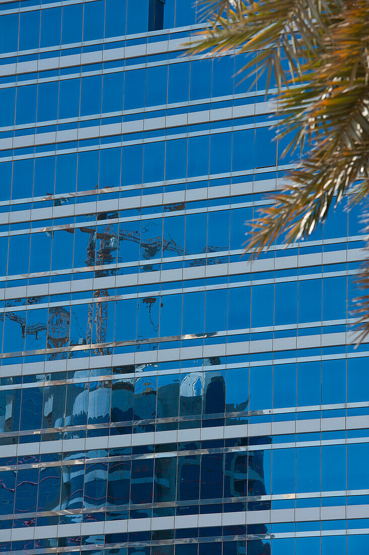 Construction Cranes Reflected In Office Blockabu Dhabi, United Arab Emirates
