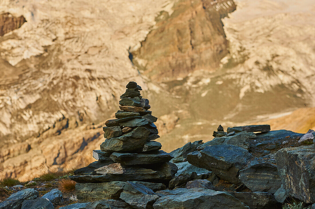 Cairns standing with Mount Großglockner (Mount Grossglockner) in the background beside Gamsgrubenweg, Franz-Joseph-Höhe on an early morning; Kärnten (Carinthia), Austria